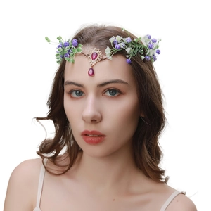 Detail of vintage forehead chain with gold leaves, purple flowers and pink teardrop gems