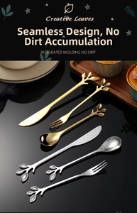 Close-up of creative leaf-shaped stainless steel spoons and forks on a dessert tray