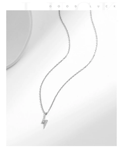 Macro detail of silver S925 lightning bolt necklace pendant with sparkling zircons