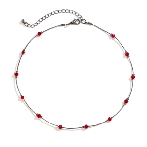 Detail of gothic silver choker featuring red faceted beads and adjustable lobster clasp