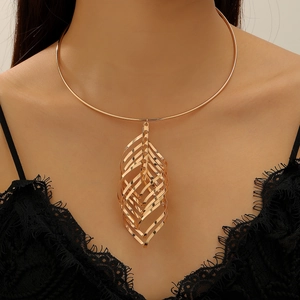Detailed view of a gold hollow layered leaf pendant on a metallic choker necklace