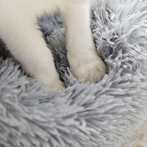 Soft light grey plush round pet bed featuring thick faux fur texture for winter warmth