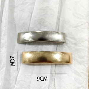 Detail view of 9cm brushed metal barrette clips in gold and silver finishes