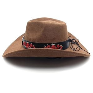 Detail of western cowboy hat featuring floral embroidery and silver bull head studs