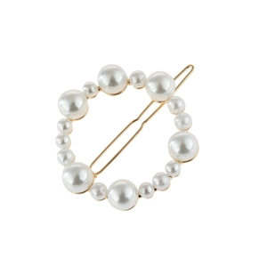 Detail of golden circle hair clip decorated with white imitation pearls on white background