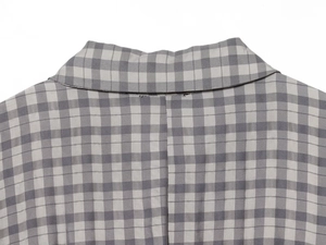 Close-up detail of the grey plaid collar and stitching on this short checkered dress
