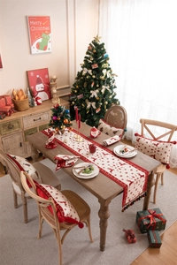 Detailed view of jacquard table runner and cushions with reindeer and snowflake patterns