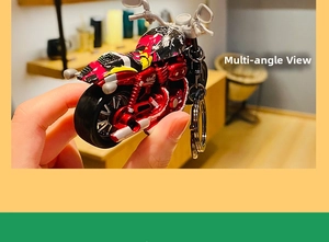 Detail of red and black alloy motorcycle keychain with dual metal rings in hand