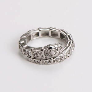 Detailed macro shot of a silver snake-shaped ring with pavé-set shimmering crystals