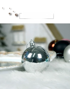 Close-up of a glossy silver Christmas ball ornament with a reflective mirror finish