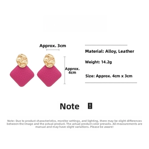 Detail showing pink leather rhombic pendant earrings with gold textured round studs