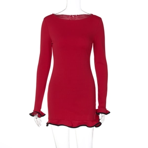 Detail of red slim-fit dress featuring black ruffle trim on long sleeves and hemline