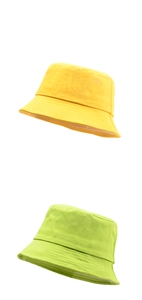 Detailed texture of yellow and light green cotton canvas bucket hats on white background
