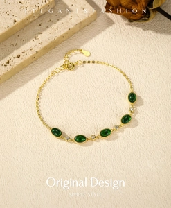 Close-up of elegant S925 silver bracelet with green oval stones and small clear gems