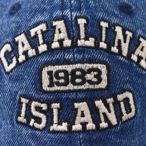 Macro shot of vintage 1983 embroidery on washed denim baseball cap with 3D stitching
