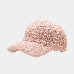Close-up of pink faux fur baseball cap showing thick plush texture and warm material