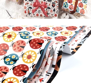 Detail of colorful gift wrapping paper featuring cartoon animals and floral patterns