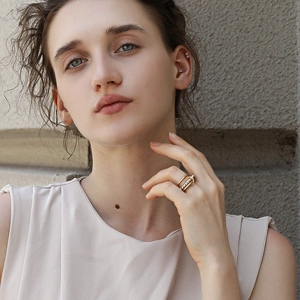 Three-layer 18K gold plated stainless steel ring set worn by a model in a minimalist style