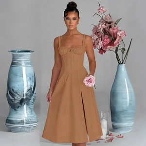 Detail of a brown midi dress featuring a structured corset top and side slit detail
