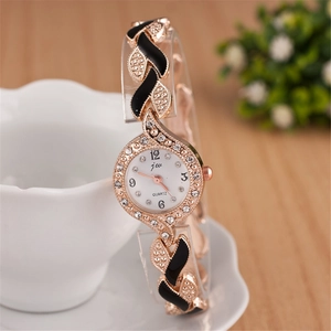 Detailed macro view of rose gold quartz watch with rhinestones and black enamel accents