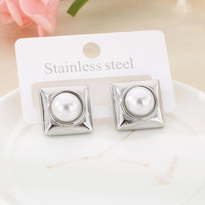 Detail of square stainless steel stud earrings with white faux pearl in a silver setting