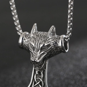 Detailed close-up of retro wolf head pendant in matte stainless steel with Celtic knot