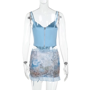 Detail of light blue lace corset top with back zipper and matching printed mini skirt