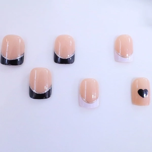 French short square press-on nails with nude base, black heart, and silver glitter lines