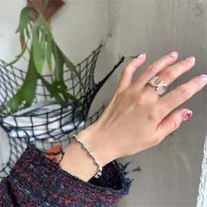 Minimalist S925 sterling silver U-shaped ring and bamboo link bracelet set on model hand