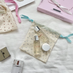 Floral corduroy drawstring pouches with blue and pink ribbons for travel cosmetics storage