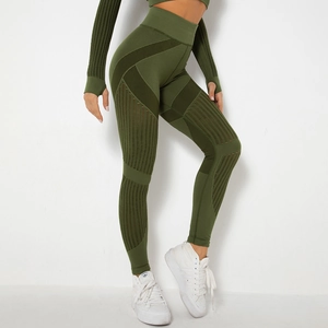 Detail of high-waist seamless dark green yoga pants with vertical ribbing and breathable mesh