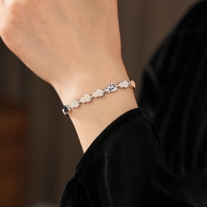 Detail of silver auspicious cloud link bracelet showing polished finish and textures