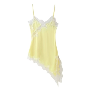 Close-up of yellow satin dress featuring delicate white lace trim and asymmetrical hem