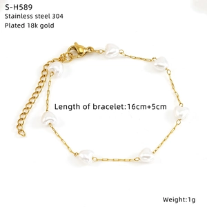 Detail of 18k gold plated heart charm and white beads on a 304 stainless steel bracelet