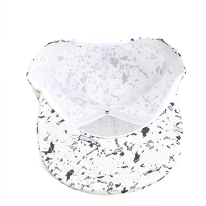 Detail view of cotton hip-hop flat brim hat interior with splash ink pattern and care label