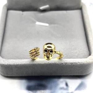 Minimalist S925 sterling silver skull ring in gold finish shown in a velvet jewelry box