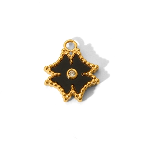 Detail of gold-plated palm eye pendant with black star and turquoise inlay