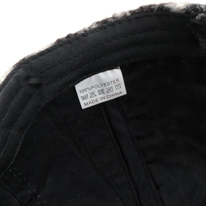 Detailed close-up of 100% polyester lining and internal label of leopard baseball cap