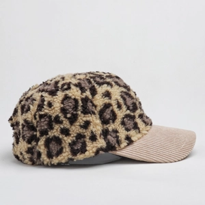Detail of leopard print fleece and beige corduroy fabric on a retro baseball cap