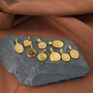 Collection of vintage gold stainless steel pendants with Roman motifs on stone base