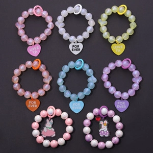 Detailed view of colorful beaded phone straps with heart pendants and cartoon charms