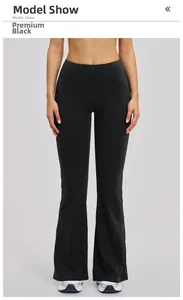 Close-up of black high-waisted flared yoga pants showing tummy control waistband and slim fit