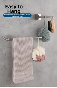 Detail view of wall-mounted stainless steel towel rack in matte finish on a concrete wall