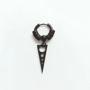 Detail of black punk hoop earring with dragon engraving and long spiked cone pendant