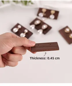 Close-up of 0.45cm thick walnut wood earring display card with natural grain texture