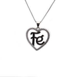 Macro shot of silver heart pendant with cubic zirconia inlay and black Fe lettering