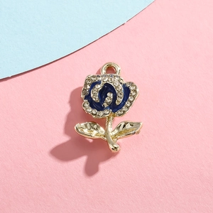 Macro detail of rose pendant charm with blue enamel petals and sparkling rhinestones