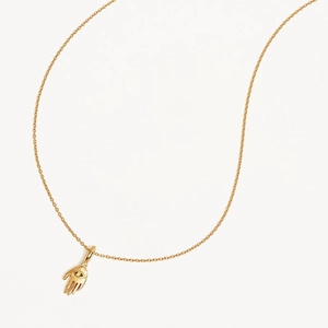 Gold Hamsa Hand necklace with eye symbol and sparkling zircon on white background