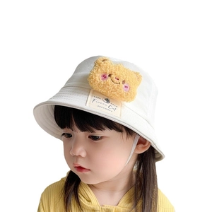 White children's cotton bucket hat with yellow plush bear decoration for sun protection