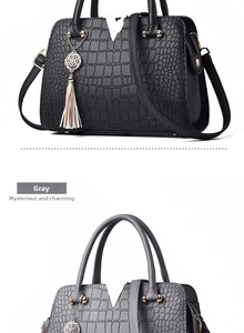Detail of crocodile pattern handbags in black and gray with golden V-hardware and tassels